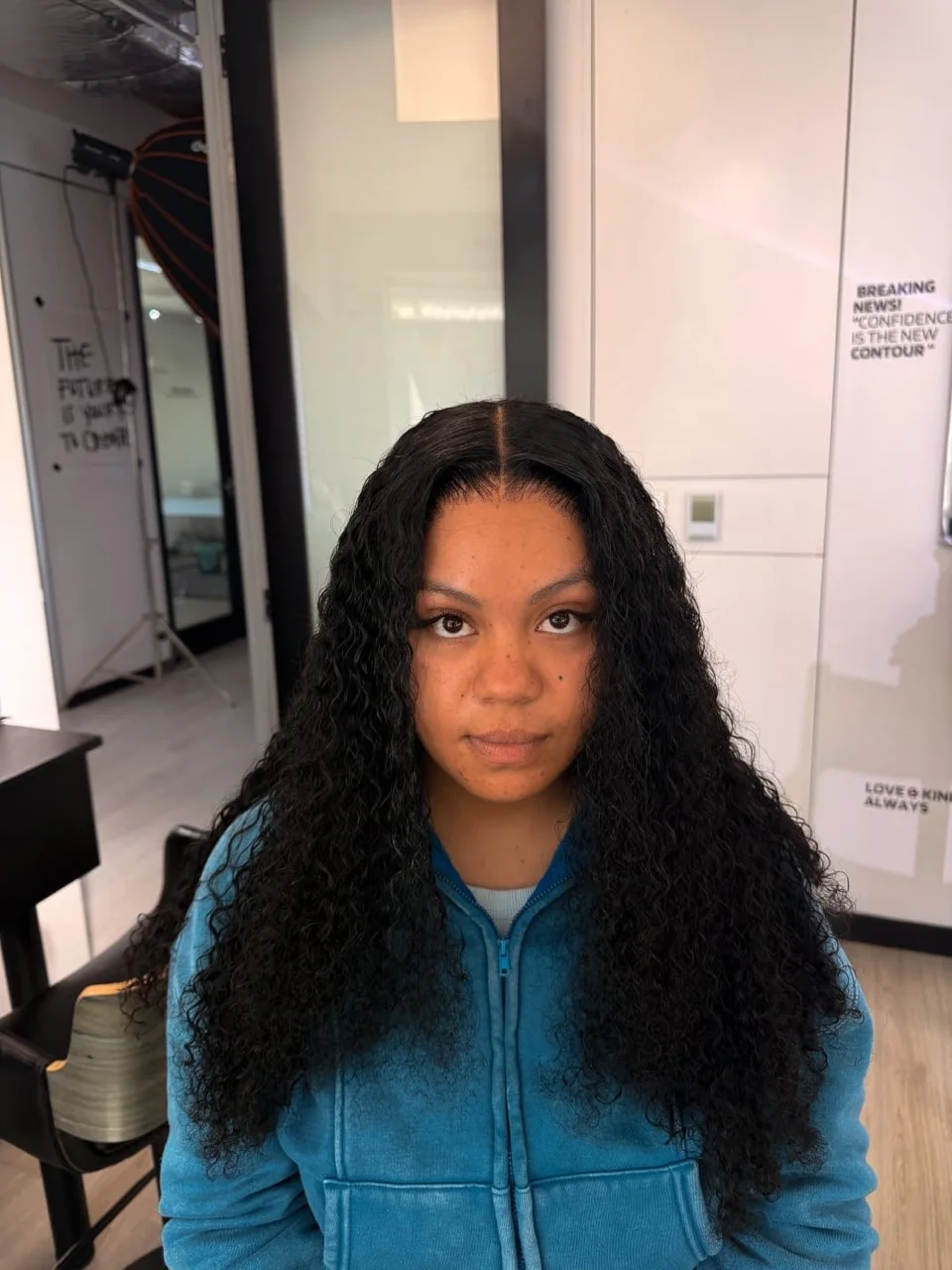 Long centre-part curls installed by BY LIS